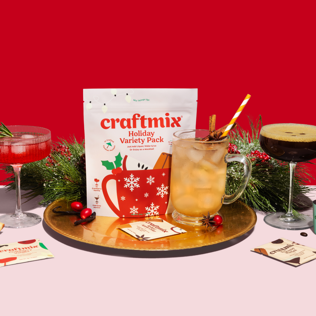 Craftmix cocktail drink mixes with colorful drinks and fresh fruit garnishes on a pink marble background.