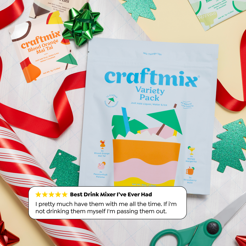 Group of friends holding colorful Craftmix cocktails in blue cups with striped straws, featuring fresh garnishes and a Craftmix Variety Pack pouch.