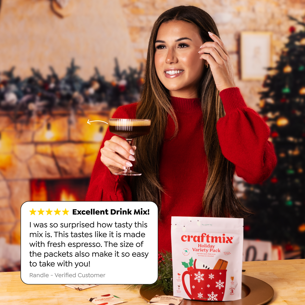 Craftmix Espresso Martini and Strawberry Mule cocktails with drink mix packets, fresh fruit, and garnishes on a cream-colored surface.